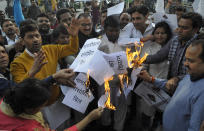 NOIDA, INDIA - DECEMBER 11: Congress party workers burn a copy of the proposed bill during a protest against the BJP and the Citizenship Amendment Bill (CAB) at Sector 18, on December 11, 2019 in Noida, India. Normal life came to a halt on Tuesday in several states amid protests over the Citizenship (Amendment) Bill. The Bill, piloted by Union home minister Amit Shah, was comfortably passed in the Lok Sabha on Monday night. Home Minister Amit Shah on Wednesday moved the Citizenship (Amendment) Bill in the Rajya Sabha and sought to assuage the concerns of Indian Muslims by saying they have nothing to fear as they are and will remain citizens of India. (Photo by Sunil Ghosh/Hindustan Times via Getty Images)