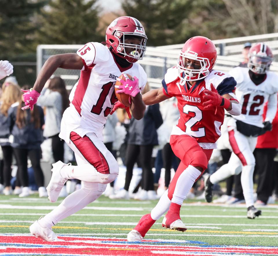 Brockton's Mauricio Powell, carries the football next to Bridgewater-Raynham defender Jaimir Lawson, during a game on Thursday, Nov. 25, 2021. 