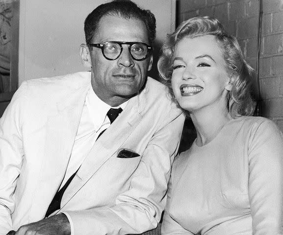 <p>Fox Photos/Hulton Archive/Getty Images</p> Marilyn Monroe with then-husband Arthur Miller at London Airport on July 14, 1956.