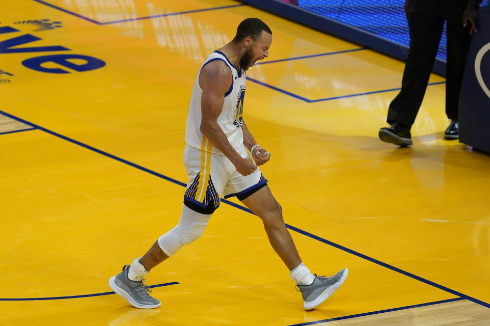 Golden State Warriors guard Stephen Curry (30) reacts after shooting a 3-point basket against the Memphis Grizzlies during the second half of an NBA basketball game in San Francisco, Sunday, May 16, 2021. (AP Photo/Jeff Chiu)