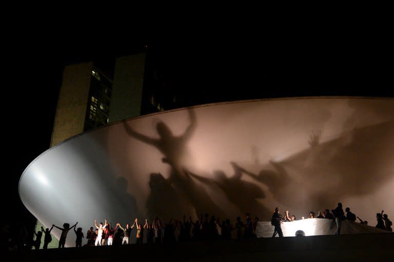 Students shout slogans after taking the National Congress during a protest on June 17, 2013 in Brasilia. Demonstrators focused their anger not just on transport fares but also on $15 billion the government is allocating for the Confederations Cup and the World Cup