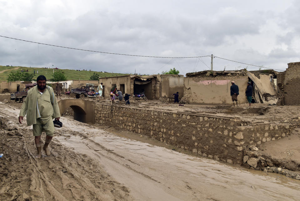 People clean up their damaged homes after heavy flooding in Baghlan province in northern Afghanistan Saturday, May 11, 2024. Flash floods from seasonal rains in Baghlan province in northern Afghanistan killed dozens of people on Friday, a Taliban official said. (AP Photo/Mehrab Ibrahimi)