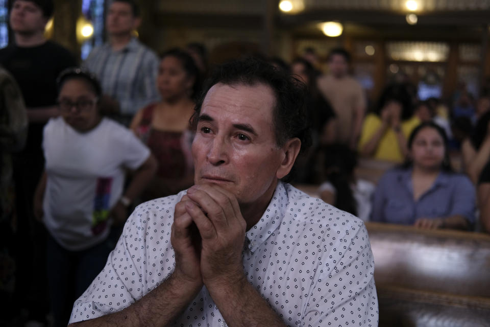 A parishioner prays during a Mass at St. Peter the Apostle Catholic Church in Reading, Pa., on Sunday, June 9, 2024. (AP Photo/Luis Andres Henao)