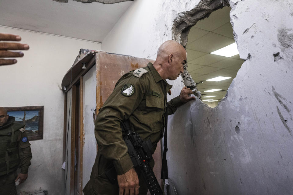 An Israeli army officer inspects a damaged synagogue after it was hit by a rocket fired from the Gaza Strip, in Ashkelon, Israel, Sunday, May 16, 2021. (AP Photo/Tsafrir Abayov)