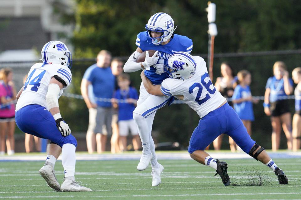 Highlands' Charlie Noon (1) is tackled by Simon Kenton's James Allen (26) after making a catch during a KHSAA high school football game at Highlands High School Friday, Aug. 26, 2022. Highlands is 10th in the state in 5A this week.