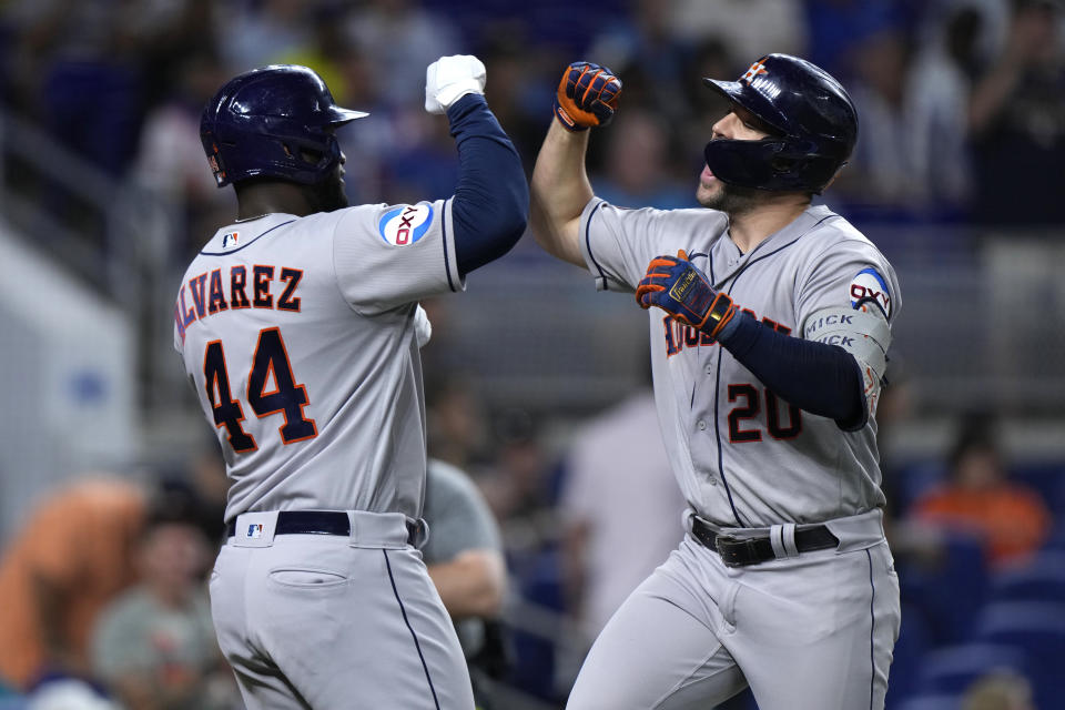 Houston Astros' Chas McCormick (20) celebrates with Houston Astros' Yordan Alvarez (44) after McCormick hit a home run scoring Alvarez during the first inning of a baseball game against the Miami Marlins, Wednesday, Aug. 16, 2023, in Miami. (AP Photo/Wilfredo Lee)