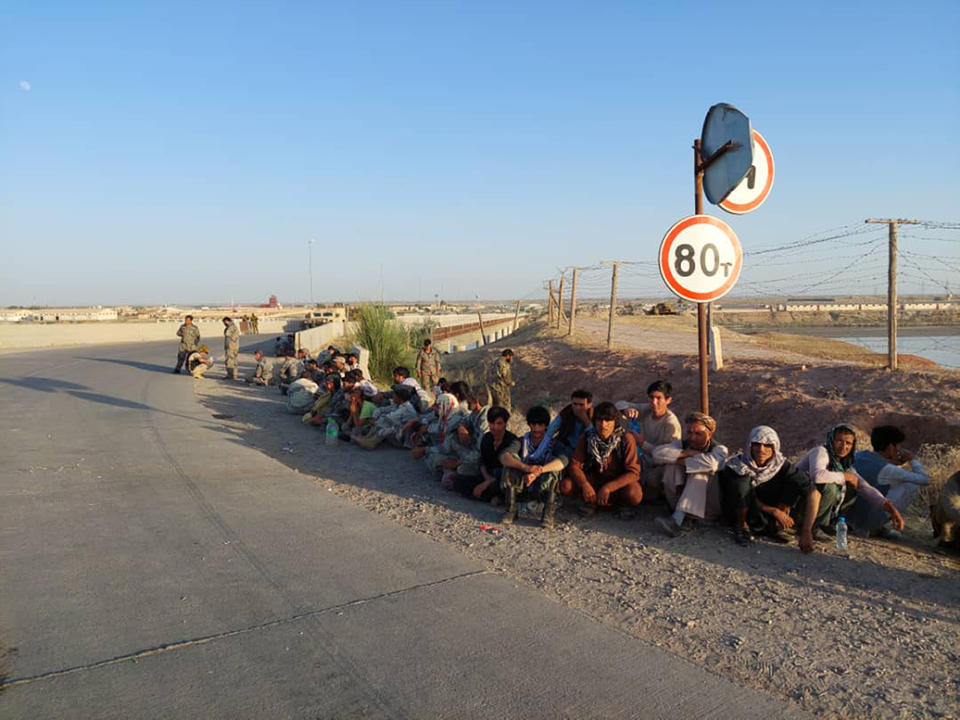 In this handout photo released by Border Troops of the State Committee for National Security of the Republic of Tajikistan on Tuesday, June 22, 2021, Afghanistan's government soldiers sit at a bridge next to Tajikistan-Afghanistan border in Tajikistan. 134 servicemen of the government forces of Afghanistan were forced to retreat through of the Panj frontier detachment into the territory of the Republic of Tajikistan on Tuesday, June 22, 2021. The Taliban's march through northern Afghanistan gained momentum overnight with the capture of several districts from fleeing Afghan forces, several hundred of whom fled across the border into Tajikistan, officials said Sunday. More than 300 Afghan military personnel crossed from Afghanistan's Badakhshan province as Taliban fighters advanced toward the border, Tajikistan's State Committee for National Security said in a statement. (Border Troops of the State Committee for National Security of the Republic of Tajikistan via AP)