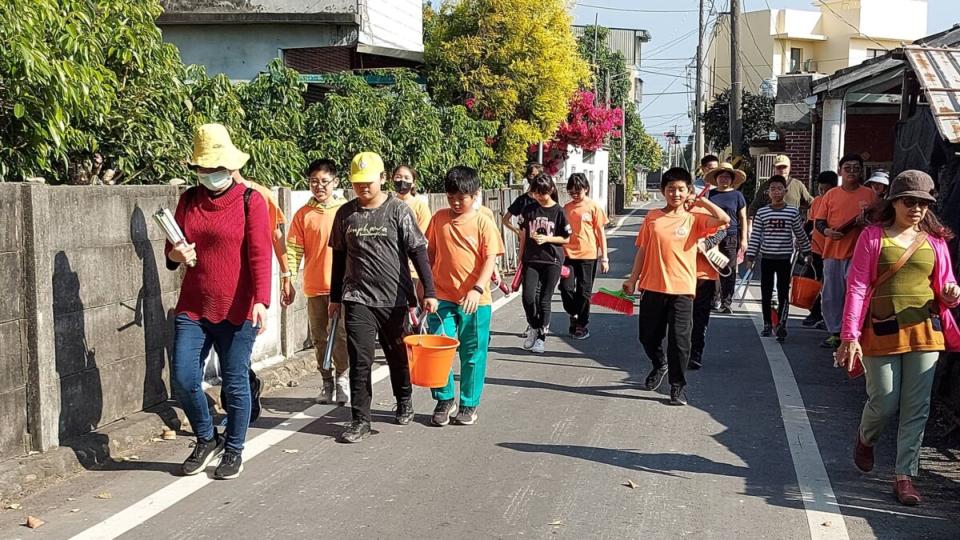 ▲福德國小學生在師長帶領下一路步行清淨厝邊家園環境及關懷社區獨老生活。（記者林明佑翻攝）