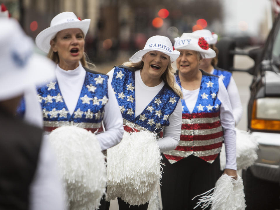 From left, Debbie Bigler, 66; Colleen Minisce, 61, and Janis Kramer, 75, all members of the Milwaukee Dancing Grannies, prepare to march in the Veterans’ Day parade in Milwaukee on Saturday, Nov. 5, 2022. Kramer, right, has been a Dancing Granny for about 19 years. Bigler and Minisce are among a crop of newer members who are helping the Grannies rebuild. They perform at parades and other events throughout the year. (AP Photo/Kenny Yoo)