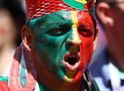 <p>Face paint was the order of the day for thousands of fans, including this Portugal supporter. (Getty) </p>