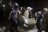 Civil defense members carry a casualty after an airstrike at a field hospital in the rebel held area of al-Sukari district of Aleppo. REUTERS/Abdalrhman Ismail