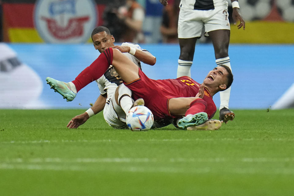 Germany's Thilo Kehrer, left, challenges for the ball with Spain's Ferran Torres during the World Cup group E soccer match between Spain and Germany, at the Al Bayt Stadium in Al Khor , Qatar, Sunday, Nov. 27, 2022. (AP Photo/Julio Cortez)