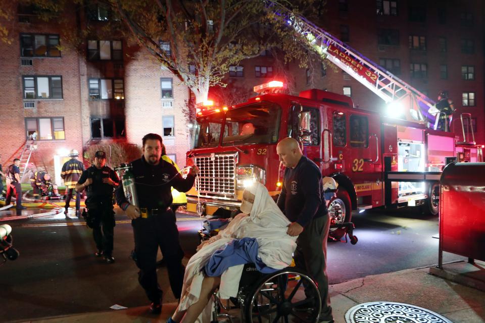 An elderly resident of the building is evacuated from the scene as White Plains firefighters battle a fire in an apartment building at 11 Lake Street  in White Plains April 18, 2023. The fire broke out shortly after midnight, injuring  several residents and leaving dozens homeless.