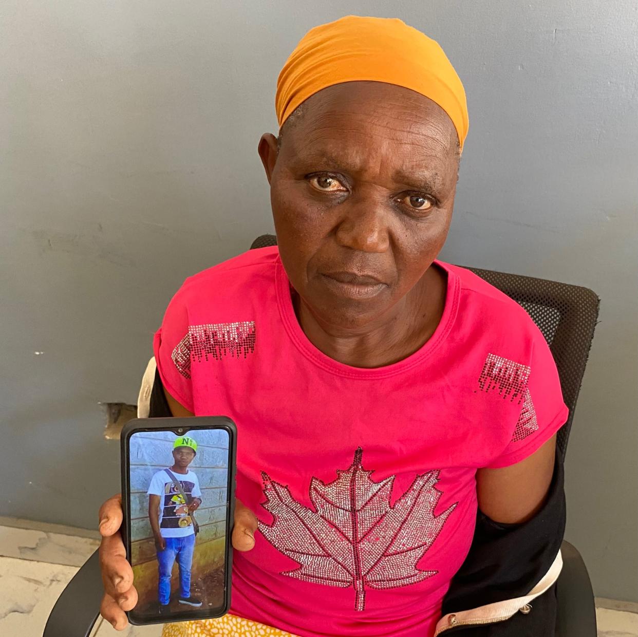 Mary Mbari with a picture of her deceased son