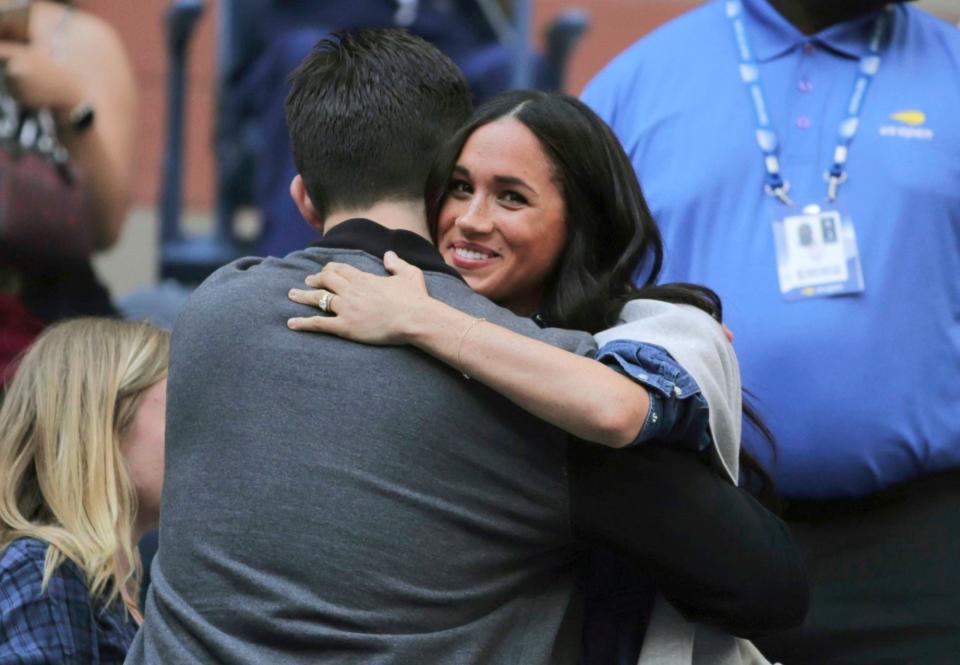 Meghan was seated behind Williams' husband, Reddit co-founder Alexis Ohanian, whom she shared a hug with before the match.