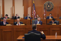 ADDS NAME Curtis Morgan, the CEO of Vistra Corp., at table, testifies as the Committees on State Affairs and Energy Resources holds a joint public hearing to consider the factors that led to statewide electrical blackouts, Thursday, Feb. 25, 2021, in Austin, Texas. The hearings were the first in Texas since a blackout that was one of the worst in U.S. history, leaving more than 4 million customers without power and heat in subfreezing temperatures. (AP Photo/Eric Gay)