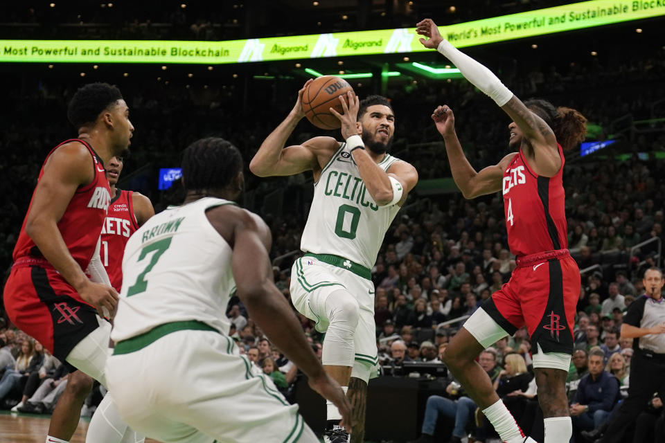 Boston Celtics forward Jayson Tatum (0) drives to the basket against the Houston Rockets during the first half of an NBA basketball game, Tuesday, Dec. 27, 2022, in Boston. (AP Photo/Charles Krupa)
