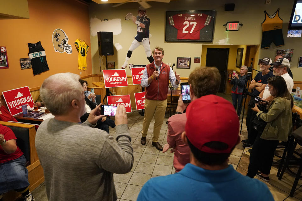 Virginia Republican gubernatorial candidate Glenn Youngkin talks with supporters during a meet and greet at a sports bar in Chesapeake, Va., Monday, Oct. 11, 2021. Youngkin faces former Governor Terry McAuliffe in the November election. (AP Photo/Steve Helber)