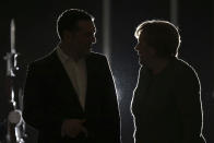 FILE - Greek Prime Minister Alexis Tsipras, left, and German Chancellor Angela Merkel talk following their meeting in Athens, on Jan. 10, 2019. Merkel has been credited with raising Germany’s profile and influence, helping hold a fractious European Union together, managing a string of crises and being a role model for women in a near-record tenure. Her designated successor, Olaf Scholz, is expected to take office Wednesday, Dec. 8, 2021. (AP Photo/Petros Giannakouris)