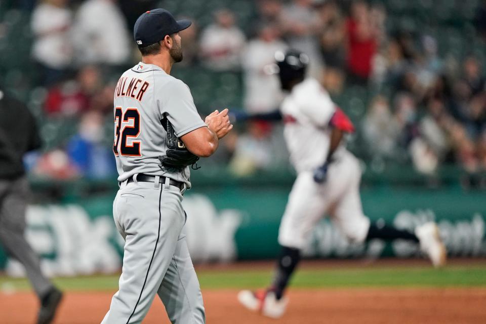 Tigers pitcher Michael Fulmer, left, waits for Cleveland DH Franmil Reyes, right, to run the bases on a solo home run during the sixth inning on Friday, April 9, 2021, in Cleveland.