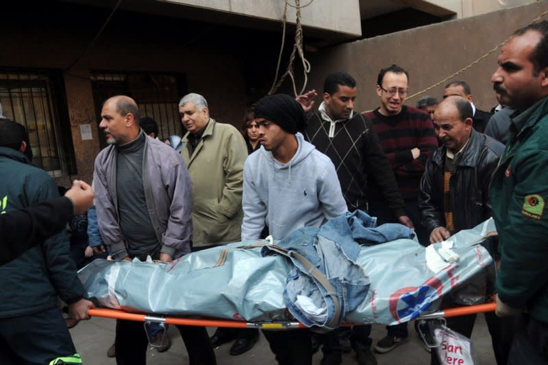 Mourners carry the body of a victim of clashes at a soccer stadium outside a morgue in Cairo, Egypt, on February 2, 2012. Scores of Egyptian soccer fans were crushed to death on February 1, 2012, while others were fatally stabbed or suffocated after being trapped in a long narrow corridor trying to flee rival fans, in the country's worst ever soccer violence that killed at least 74 people, witnesses and health officials said. File Photo by Ahmed Fred/UPI