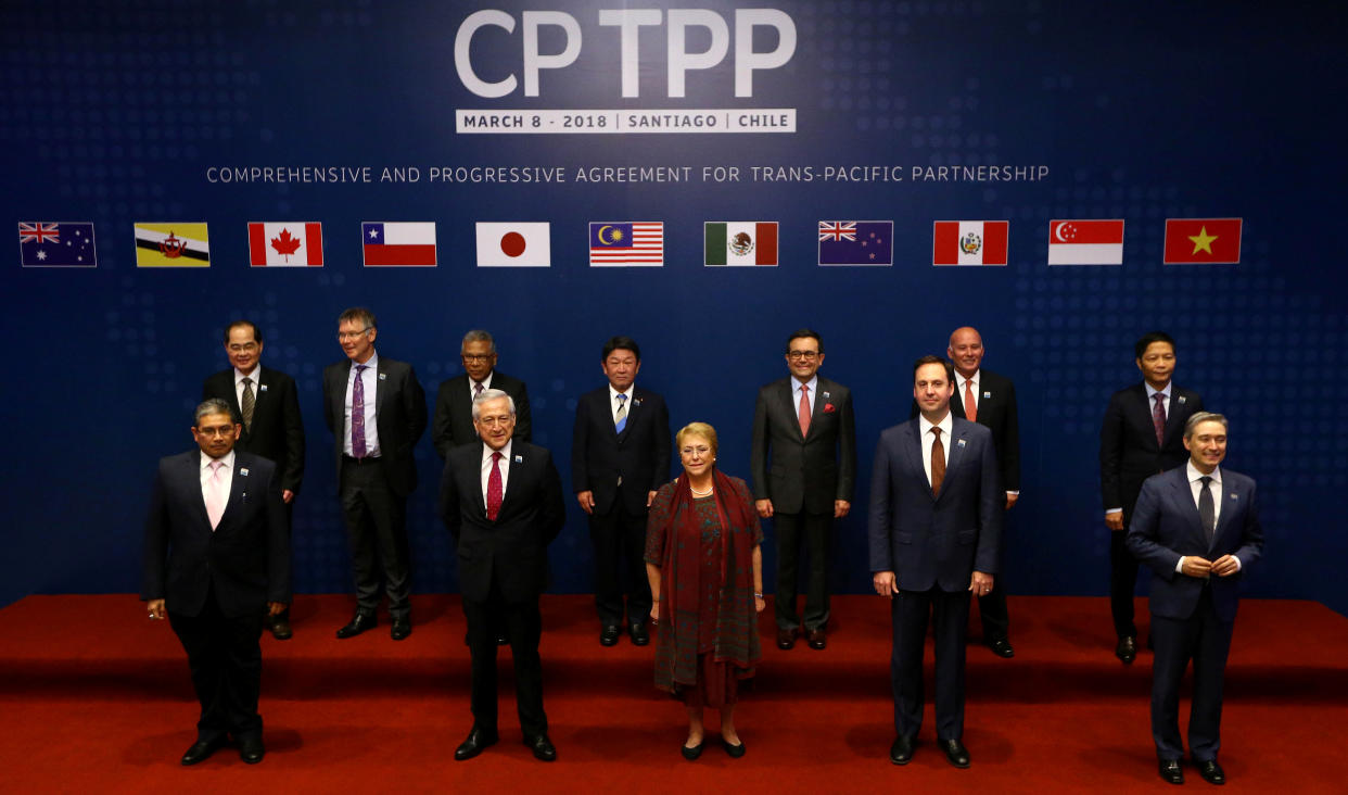 Representatives of members of Trans-Pacific Partnership (TPP) trade deal: Brunei's Acting Minister for Foreign Affairs Erywan Dato Pehin, Chile's Foreign Minister Heraldo Munoz, Chile's President Michelle Bachelet, Australia's Trade Minister Steven Ciobo and Canada's International Trade Minister Francois-Phillippe Champagne, Singapur's Minister for Trade and Industry Lim Hng Kiang, New Zealand's Minister for Trade and Export Growth David Parker, Malaysia's Minister for Trade and Industry Datuk J. Jayasiri, Japan's Minister of Economic Revitalization Toshimitsu Motegi, Mexico's Secretary of Economy  Ildefonso Guajardo Villarreal, Peru's Minister of Foreign Trade and Tourism Eduardo Ferreyros Kuppers and Vietnam's Industry and Trade Minister Tran Tuan Anh, pose for an official picture before the signing agreement ceremony in Santiago, Chile March 8, 2018. REUTERS/Ivan Alvarado