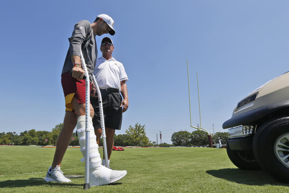 Washington's Alex Smith, left, reportedly has had 17 surgeries since breaking his right leg 11 months ago. (AP)