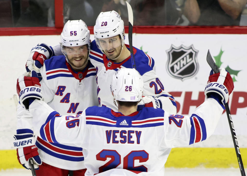 New York Rangers' Chris Kreider (20) celebrates his goal with teammates Ryan Lindgren (55) and Jimmy Vesey (26) during the third period of an NHL hockey game against the Ottawa Senators, Wednesday, Nov. 30, 2022 in Ottawa, Ontario. (Patrick Doyle/The Canadian Press via AP)