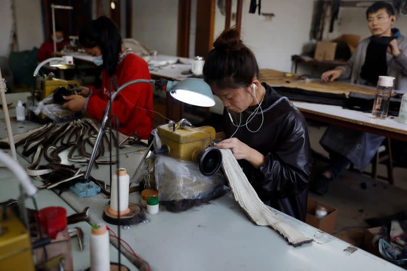 People work at a mink fur clothing factory in Shangcun