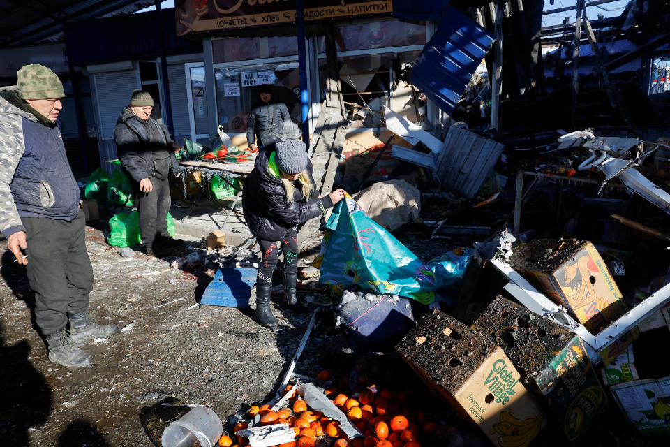 People remove debris at a food market following, what local Russian-installed authorities say, was a Ukrainian military strike in the course of Russia-Ukraine conflict in Donetsk, Russian-controlled Ukraine, January 21, 2024. REUTERS/Alexander Ermochenko