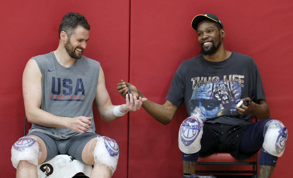 LAS VEGAS, NEVADA - JULY 07:  Kevin Love (L) #11 and Kevin Durant #7 of the 2021 USA Basketball Men's National Team share a laugh after a practice at the Mendenhall Center at UNLV as the team gets ready for the Tokyo Olympics on July 7, 2021 in Las Vegas, Nevada.  (Photo by Ethan Miller/Getty Images)