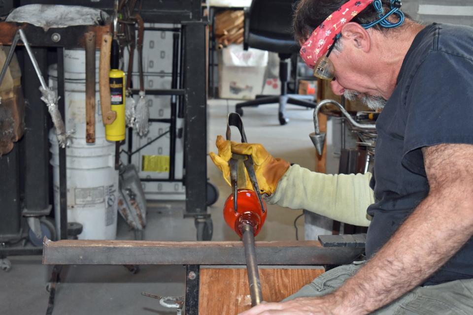 Art Ciccotti uses one of his jacks to help form the shape of a vase he created at his studio in 2021.