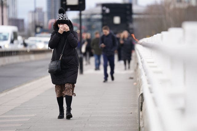 People walk across Waterloo Bridge, central London