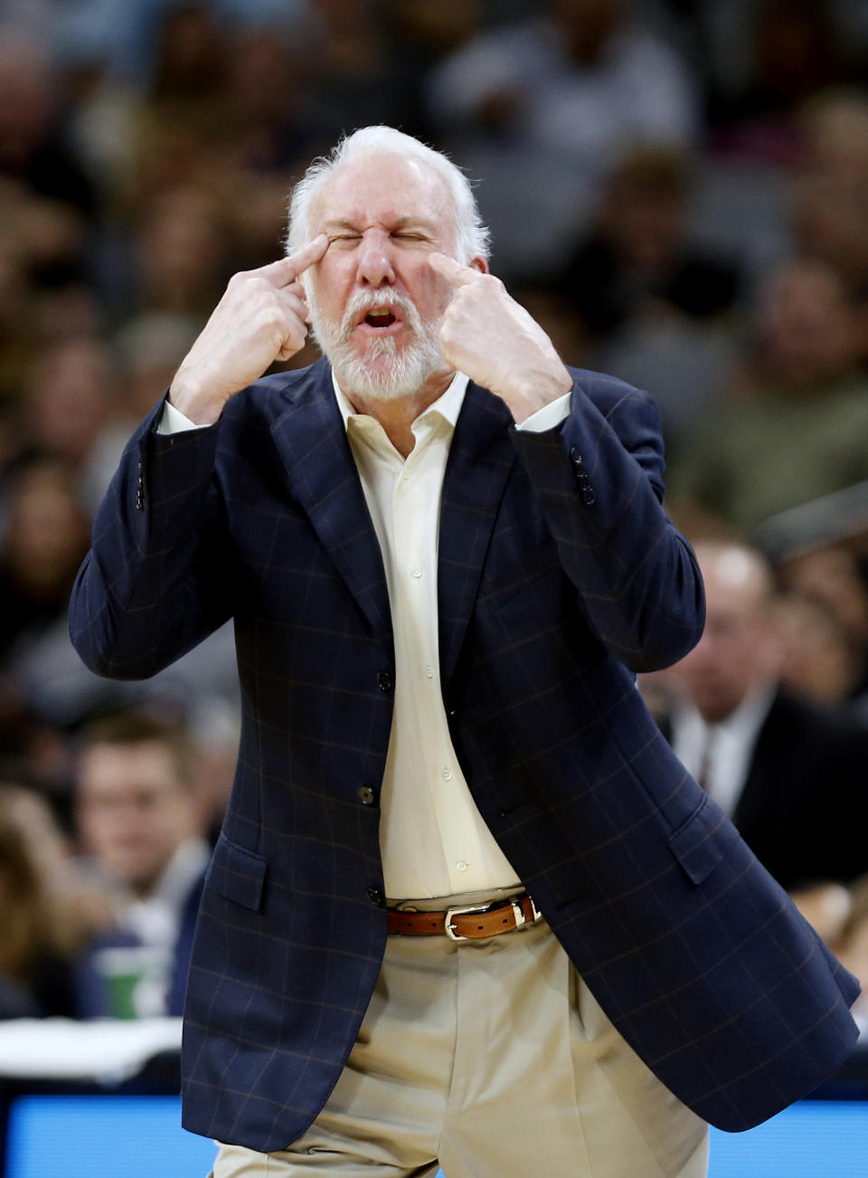 Gregg Popovich indicates where the eyes are, and that they should be open. Helpful. (Getty)