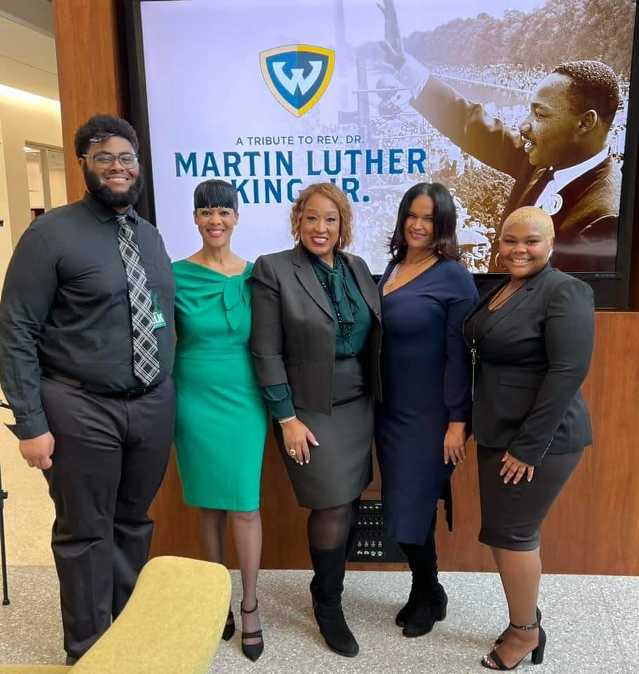 Stacie Clayton, Wayne State University's director of community affairs, stood proudly with students and community members on Jan. 13 during "A Tribute to Rev. Dr. Martin Luther King Jr.," presented by Wayne State. Clayton was joined by Wayne State student Michael Joseph, far left, next to Clayton, Wayne State alum and Detroit Public Schools Community District Board Member Sherry Gay-Dagnogo, center, to the right of Clayton, Wayne State alum Shirley Radden and Wayne State student Zaria Coleman, far right, to the left of Radden.