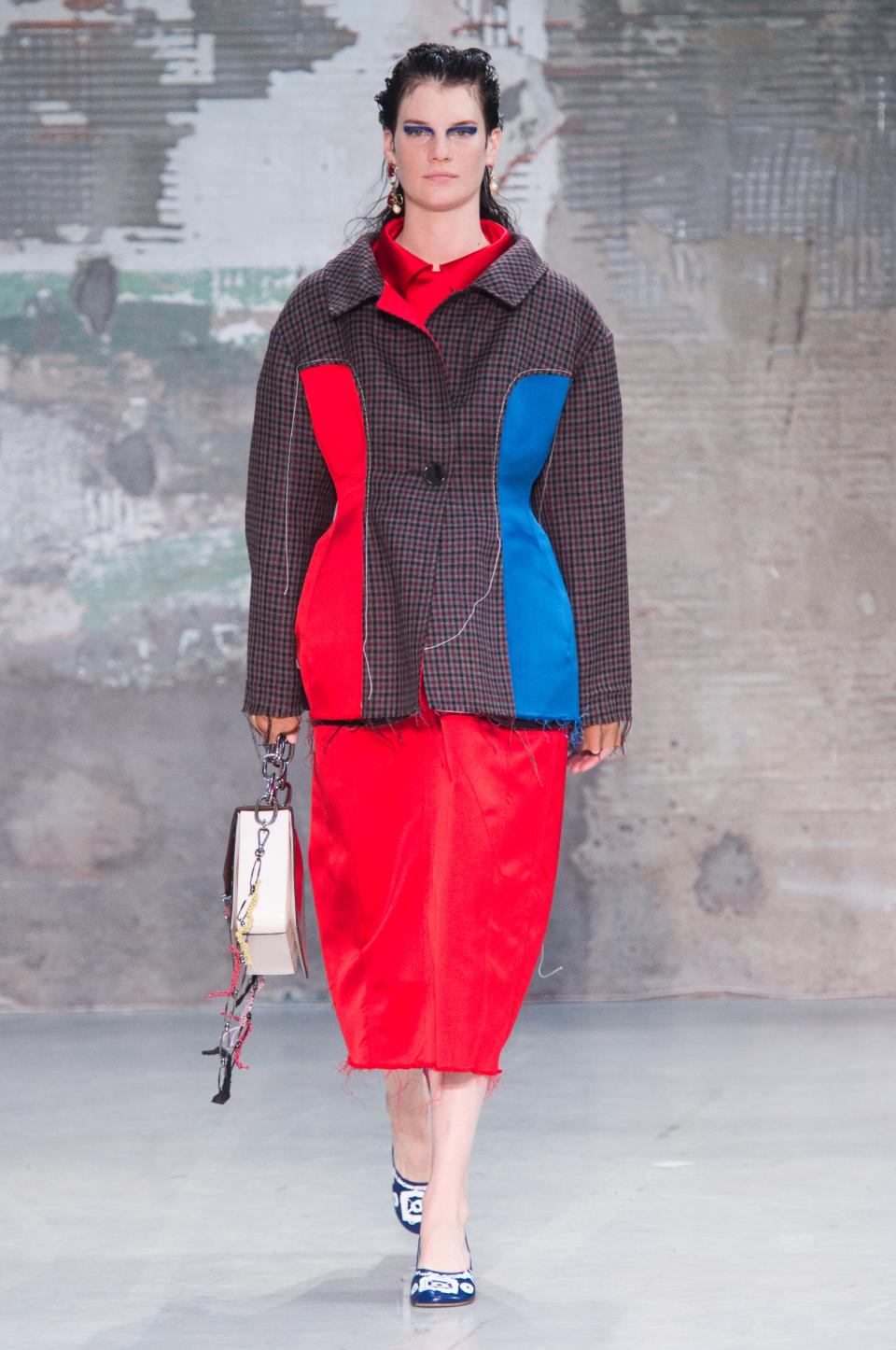 <p><i>Model wears a boxy red and blue panel jacket and collared dress from the SS18 Marni collection. (Photo: ImaxTree) </i></p>