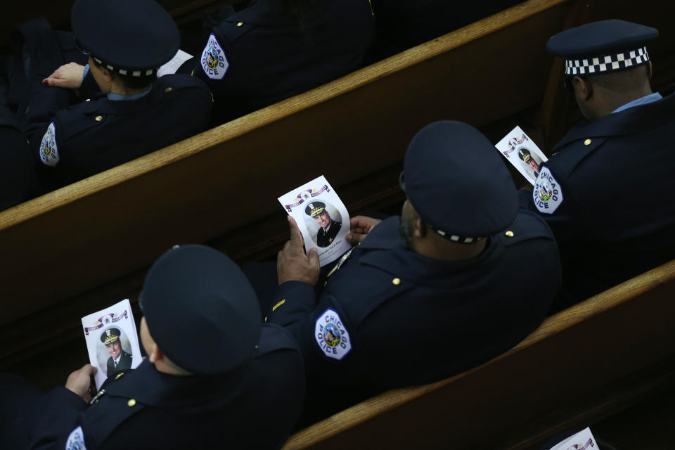 18th District Chicago police officers hold programs during the funeral mass for their slain commander, Chicago police Cmdr. Paul Bauer, at Nativity of Our Lord Roman Catholic Church on February 17, 2018 in Chicago, Illinois. Bauer was shot to death earlier in the week while confronting a suspect. (Photo by John J. Kim - Pool/Getty Images)