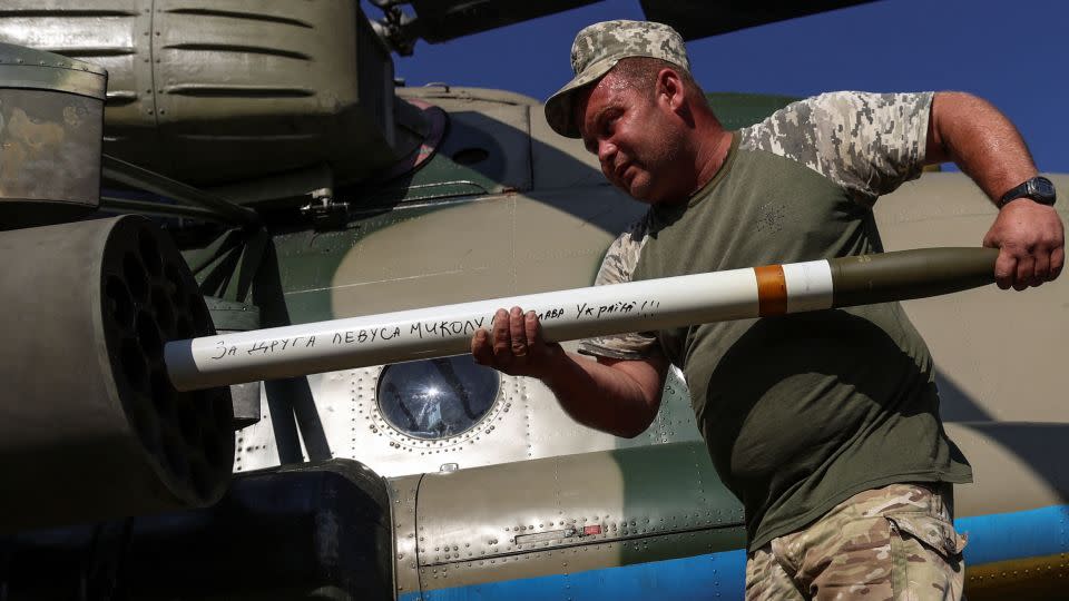 A Ukrainian serviceman loads unguided missiles into a launcher of a military Mi-8 helicopter in eastern Ukraine on Friday. - Oleksandr Ratushniak/Reuters