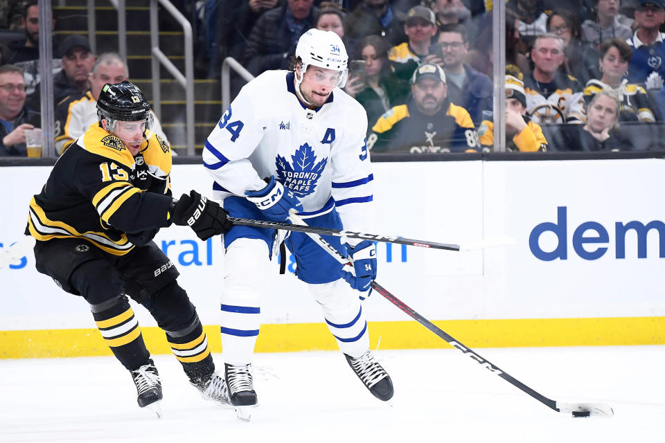 Apr 6, 2023; Boston, Massachusetts, USA; Toronto Maple Leafs center Auston Matthews (34) controls the puck from Boston Bruins center Charlie Coyle (13) during the second period at TD Garden. Mandatory Credit: Bob DeChiara-USA TODAY Sports