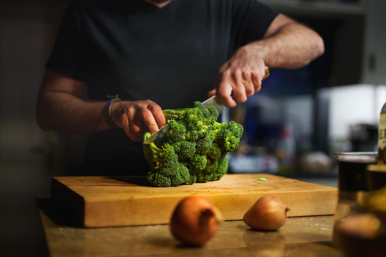 Man cutting broccoli Getty Images/Ugur Karakoc
