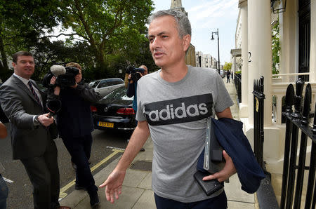 Jose Mourinho reacts to a question from a journalist as he walks towards his house in London, Britain May 27, 2016. REUTERS/Toby Melville