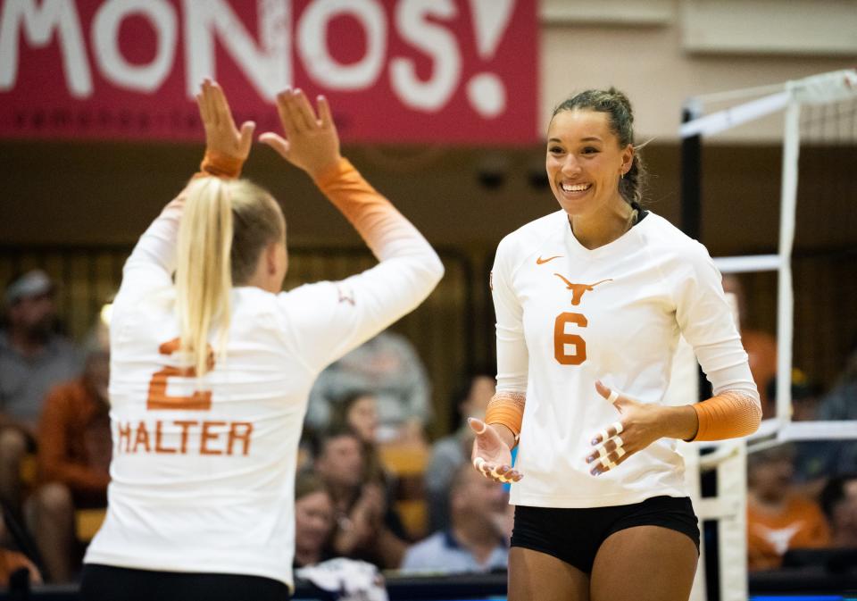 Texas outside hitter Madisen Skinner, celebrating a point with libero Emma Halter, has won three national championships during a collegiate career that started at Kentucky.