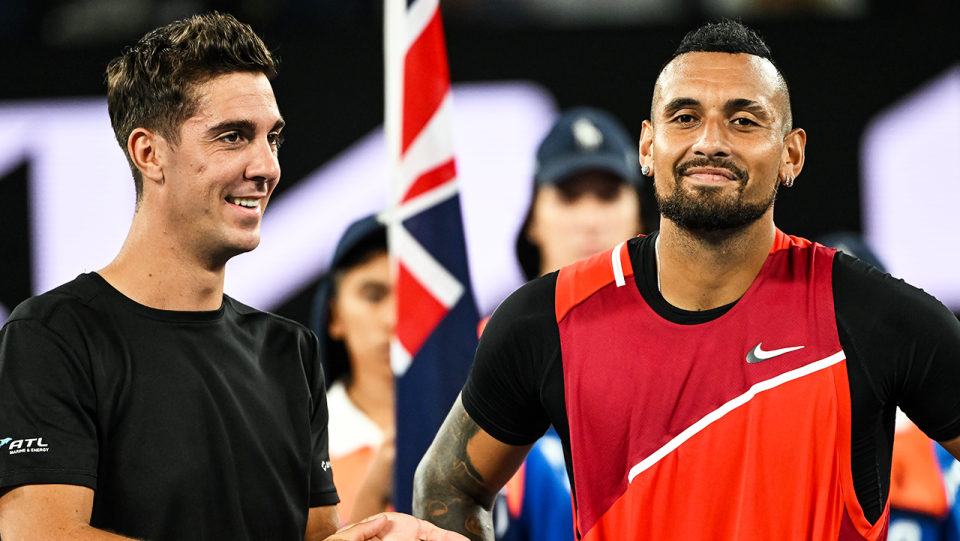 Aussie tennis players Nick Kyrgios (pictured right) and Thanasi Kokkinakis (pictured left) smile after winning the Australian Open doubles trophy.