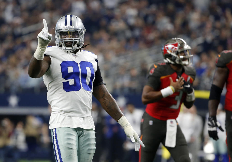 Dallas Cowboys defensive end DeMarcus Lawrence (90) celebrates as Tampa Bay Buccaneers quarterback Jameis Winston shouts in the direction of an official after throwing an incomplete pass in the second half of an NFL football game in Arlington, Texas, Sunday, Dec. 23, 2018. (AP Photo/Michael Ainsworth)