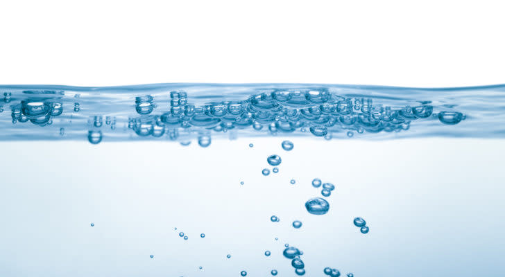 A photo of small bubbles in a container of water.