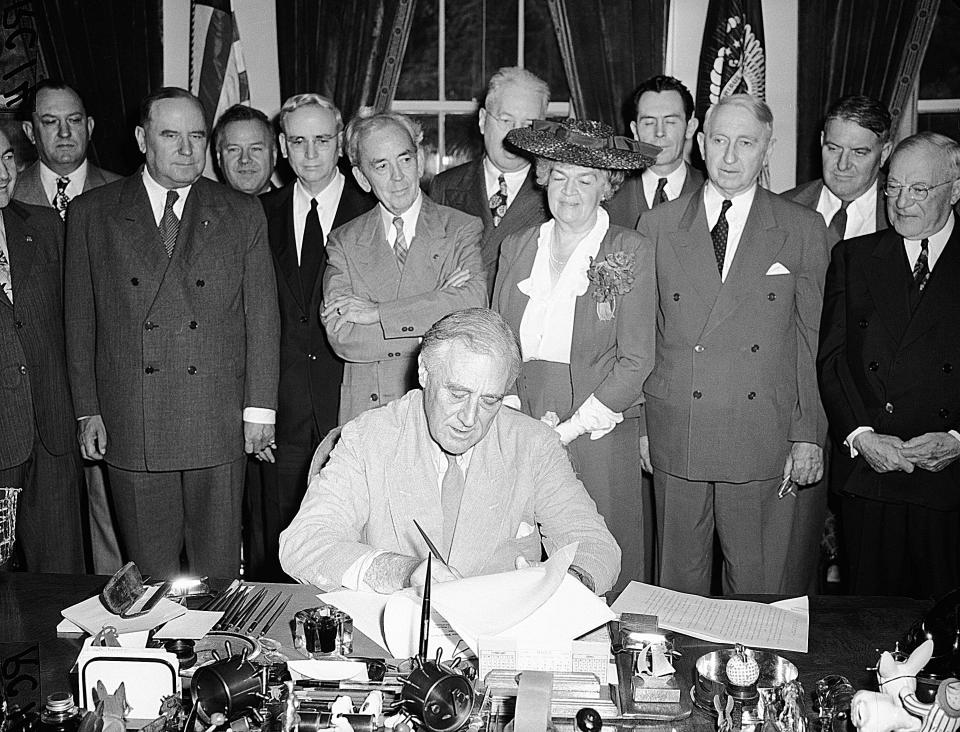 President Franklin D. Roosevelt puts his signature on the G.I. Bill of Rights at the White House, putting into law the measure for veterans aid, June 22, 1944.