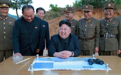 North Korean leader Kim Jong-un reacts during the long-range strategic ballistic rocket Hwasong-12 (Mars-12) test launch - Credit: KCNA / REUTERS