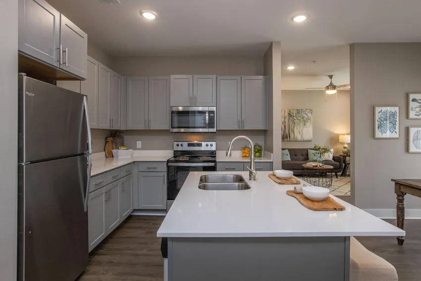 Some amenities, such as kitchen islands and pantries, are featured in select apartment units.