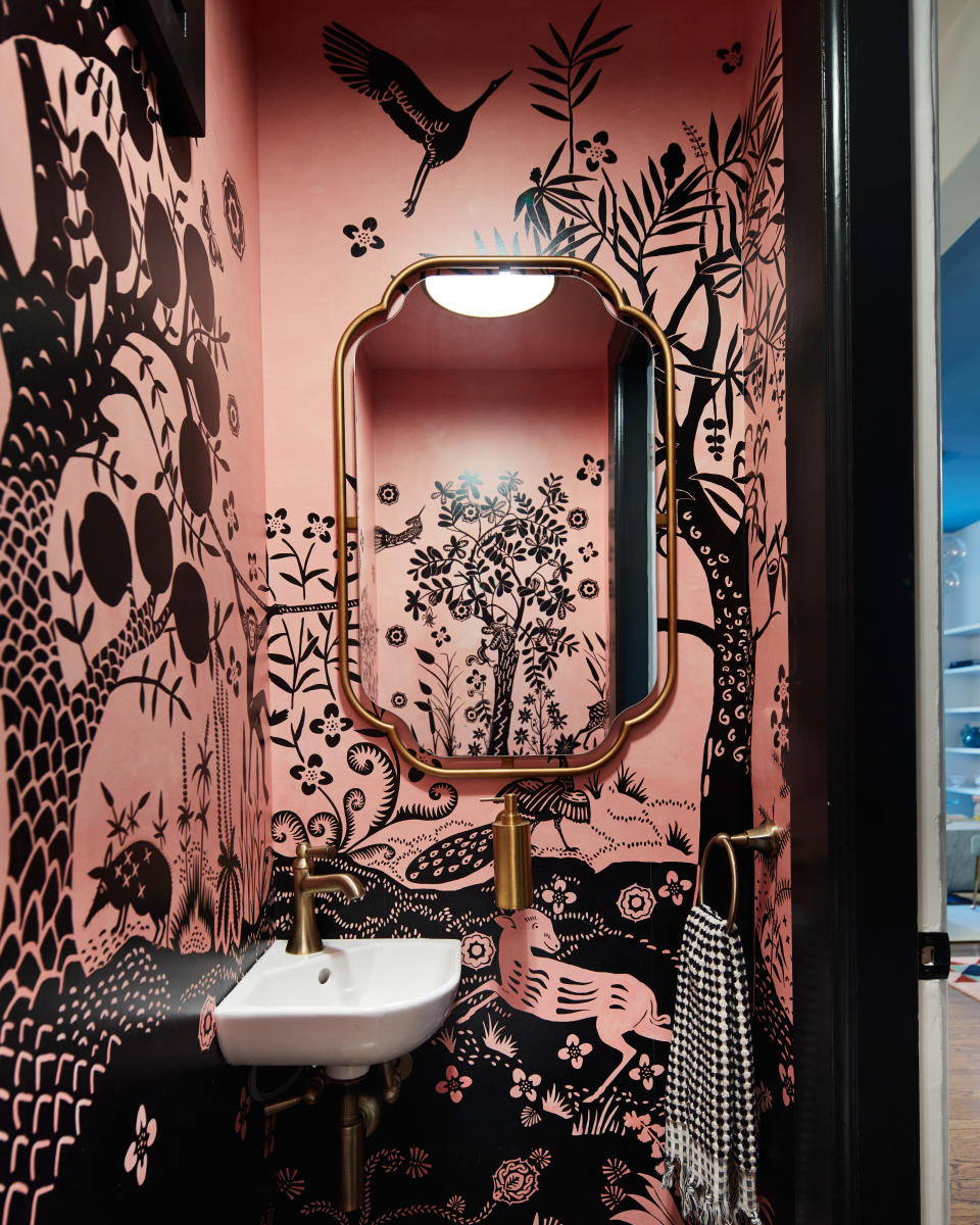 A small bathroom with botanical printed  wallpaper