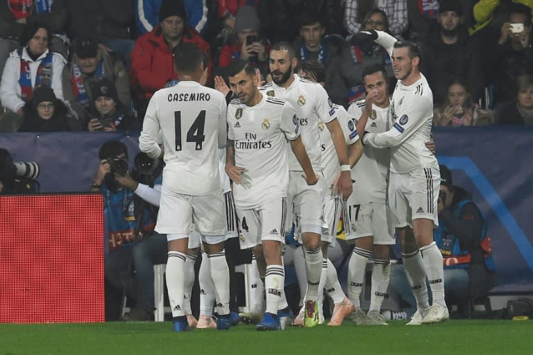 Real Madrid players celebrate with Karim Benzema (C) after the Frenchman scored in their 5-0 win away to Viktoria Plzen